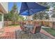 Backyard patio with a dining area under a large blue umbrella, perfect for entertaining at 6311 Xavier St, Arvada, CO 80003