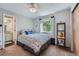 Comfortable bedroom with a large window, ceiling fan, and en suite bathroom access at 6311 Xavier St, Arvada, CO 80003