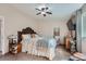 Carpeted bedroom features a decorative wood bed frame, ceiling fan, and a mounted television at 6311 Xavier St, Arvada, CO 80003