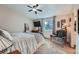 Bedroom features a plush bed, ceiling fan, TV, and a window providing natural light and garden views at 6311 Xavier St, Arvada, CO 80003