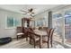 Bright dining area features a wood table, display cabinet, ceiling fan, and access to an outdoor deck at 6311 Xavier St, Arvada, CO 80003