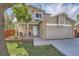 Inviting home featuring a well-manicured lawn, a quaint front porch, and brick details at 6311 Xavier St, Arvada, CO 80003