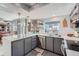 Well-lit kitchen boasts gray cabinets, stainless appliances, white countertops, and recessed lighting at 6311 Xavier St, Arvada, CO 80003