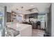 Stylish kitchen boasts an island with seating, gray cabinets, quartz countertops, and modern stainless steel appliances at 6311 Xavier St, Arvada, CO 80003