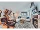 Spacious living room with a fireplace, comfortable seating, and staircase at 6311 Xavier St, Arvada, CO 80003
