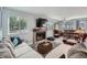 Cozy living room with a fireplace, large windows, and comfortable seating at 6311 Xavier St, Arvada, CO 80003