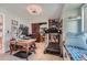 Home office includes a desk, treadmill, and built-in shelving, blending functionality and comfort at 6311 Xavier St, Arvada, CO 80003