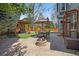 Outdoor entertaining space featuring a patio, fire pit, grill area, and artificial turf at 2861 Madison Ln, Broomfield, CO 80023