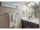 Stylish bathroom with a dark vanity, white countertop, modern fixtures, and decorative artwork at 2861 Madison Ln, Broomfield, CO 80023
