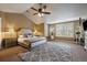 Spacious bedroom with tufted headboard, patterned rug, and a large window at 2861 Madison Ln, Broomfield, CO 80023