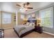 Relaxing bedroom featuring a plush bed, soft lighting, and shuttered windows at 2861 Madison Ln, Broomfield, CO 80023
