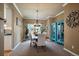 Bright dining room with stylish furnishings, elegant lighting, and decorative blue display cabinet at 2861 Madison Ln, Broomfield, CO 80023