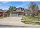 Charming two-story home with stone accents, a three-car garage, and a well-manicured front lawn at 2861 Madison Ln, Broomfield, CO 80023