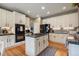 Modern kitchen features stainless steel appliances, white cabinetry, granite countertops, and a center island at 2861 Madison Ln, Broomfield, CO 80023