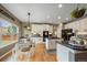 Bright kitchen features white cabinetry, granite countertops, stainless steel appliances, and a dining area at 2861 Madison Ln, Broomfield, CO 80023