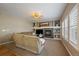 Comfortable living room with a cozy fireplace, built-in shelving, and bright windows at 2861 Madison Ln, Broomfield, CO 80023