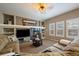 Inviting living room with a fireplace, custom built-ins, and plenty of natural light at 2861 Madison Ln, Broomfield, CO 80023