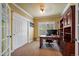 Bright home office with a wooden desk, built-in shelving, and carpeted flooring at 2861 Madison Ln, Broomfield, CO 80023