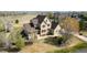 Aerial view of a two-story home with mature trees, a white fence, and a well-maintained lawn at 3225 Rinn Valley Dr, Longmont, CO 80504