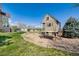 Spacious backyard features a custom playhouse, a level grassy area, and mature trees for outdoor enjoyment at 3225 Rinn Valley Dr, Longmont, CO 80504