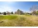 Expansive backyard with lush green lawn, white fencing, and ample space for outdoor activities at 3225 Rinn Valley Dr, Longmont, CO 80504