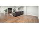 Spacious basement featuring durable wood floors, a comfortable sofa, and a TV for entertainment at 3225 Rinn Valley Dr, Longmont, CO 80504