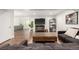 Relaxing basement featuring wood floors, a comfortable sofa, and a TV for entertainment at 3225 Rinn Valley Dr, Longmont, CO 80504