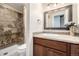 Well-maintained bathroom with tiled walk-in shower, dark wood vanity, and neutral tile at 3225 Rinn Valley Dr, Longmont, CO 80504
