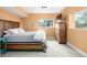 Serene bedroom with rustic wood accents, a comfortable bed, and plenty of natural light for a peaceful retreat at 3225 Rinn Valley Dr, Longmont, CO 80504