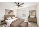 Bright bedroom with modern decor, a ceiling fan, and a comfortable bed with side tables at 3225 Rinn Valley Dr, Longmont, CO 80504