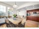 Charming dining area with hardwood floors, large windows, and an open layout to the living room at 3225 Rinn Valley Dr, Longmont, CO 80504