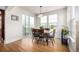 Bright dining area with hardwood floors, sliding door to patio and large windows at 3225 Rinn Valley Dr, Longmont, CO 80504