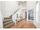 Bright foyer with hardwood floors, staircase, and decorative console table at 3225 Rinn Valley Dr, Longmont, CO 80504
