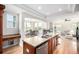 Open-concept kitchen featuring a large island, stainless steel appliances, and hardwood floors at 3225 Rinn Valley Dr, Longmont, CO 80504