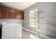 Well-lit laundry room with overhead cabinets, metal shelving, and tile flooring at 3225 Rinn Valley Dr, Longmont, CO 80504