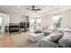 Spacious living room features a cozy fireplace, plush seating, and plenty of natural light at 3225 Rinn Valley Dr, Longmont, CO 80504