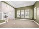 Spacious living room with large windows, a high ceiling, and neutral carpet at 3225 Rinn Valley Dr, Longmont, CO 80504