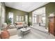 Elegant living room with tray ceilings, large windows, neutral colored furniture, and an open doorway at 3225 Rinn Valley Dr, Longmont, CO 80504