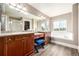 Spacious bathroom featuring double vanities, a makeup table, soaking tub and wood-style flooring at 3225 Rinn Valley Dr, Longmont, CO 80504