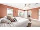 Comfortable main bedroom featuring a sliding barn door leading to a sitting room and arched entrance to the bathroom at 3225 Rinn Valley Dr, Longmont, CO 80504