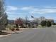 Welcoming neighborhood entrance with American flag and mountain views at 3225 Rinn Valley Dr, Longmont, CO 80504