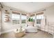 Comfortable sitting room filled with natural light from large windows and featuring a stylish glass coffee table at 3225 Rinn Valley Dr, Longmont, CO 80504