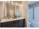 Bright bathroom featuring double sinks, dark cabinets, and neutral paint at 7897 S Jamestown Ct, Aurora, CO 80016