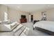 Large bedroom featuring soft natural light, carpet, and a relaxing seating area at 7897 S Jamestown Ct, Aurora, CO 80016