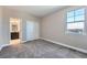 Bedroom with carpet, a window, and a door to the en-suite bathroom at 7897 S Jamestown Ct, Aurora, CO 80016