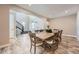 Charming dining room with a rustic wood table, contemporary lighting, and wood floors at 7897 S Jamestown Ct, Aurora, CO 80016