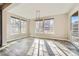 Bright dining room with wood floors and several large windows providing abundant natural light at 7897 S Jamestown Ct, Aurora, CO 80016