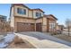 Lovely two-story home featuring stone accents, a spacious garage and a long drive way at 7897 S Jamestown Ct, Aurora, CO 80016