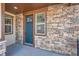 Inviting front entry with a craftsman-style door, stone accents, and ample natural light at 7897 S Jamestown Ct, Aurora, CO 80016