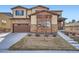 Charming home featuring a stone facade, covered porch, and a manicured front yard at 7897 S Jamestown Ct, Aurora, CO 80016